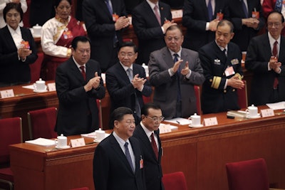 Leaders applaud as Chinese President Xi Jinping, foreground left, and Chinese Premier Li Keqiang, foreground right, arrive at the opening session of the China's National People's Congress at the Great Hall of the People in Beijing, Tuesday, March 5, 2019. Image credit: AP Photo/Andy Wong