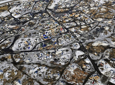 This Feb. 13, 2017 aerial photo shows the Oceti Sakowin camp, where people have gathered to protest the Dakota Access pipeline on federal land in Cannon Ball, N.D. South Dakota Gov. Kristi Noem says she's proposing legislation ahead of the Keystone XL oil pipeline's construction that would create a legal avenue to pursue out-of-state money that funds protests aimed at slowing construction. Noem's bills come after opponents of the Dakota Access oil pipeline staged large protests that resulted in 761 arrests in southern North Dakota over a six-month span beginning in late 2016. The state spent tens of millions of dollars policing the protests. (Tom Stromme/The Bismarck Tribune via AP)
