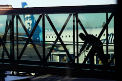 In this March 4, 2019, file photo a worker cleans a jet bridge before passengers boarded an Alaska Airlines flight to Portland, Ore., at Paine Field in Everett, Wash. Image credit: AP Photo/Ted S. Warren, File