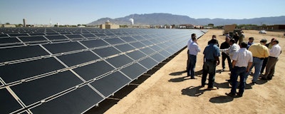 This April 20, 2011 file photo shows officials with Arizona-based First Solar and Public Service Co. of New Mexico gathering after the dedication of the utility's new 2-megawatt photovoltaic solar array in Albuquerque, N.M. New Mexico lawmakers are considering legislation during the 2019 session that sets aggressive new quotas for renewable energy production and attempts to address some of the economic costs of closing a coal-fired power plant near Farmington, N.M. (AP Photo/Susan Montoya Bryan)
