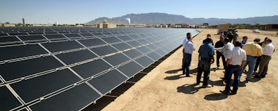 This April 20, 2011 file photo shows officials with Arizona-based First Solar and Public Service Co. of New Mexico gathering after the dedication of the utility's new 2-megawatt photovoltaic solar array in Albuquerque, N.M. New Mexico lawmakers are considering legislation during the 2019 session that sets aggressive new quotas for renewable energy production and attempts to address some of the economic costs of closing a coal-fired power plant near Farmington, N.M. (AP Photo/Susan Montoya Bryan)