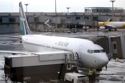 In this Oct. 4, 2017, file photo, SilkAir's new Boeing 737 Max 8 aircraft is seen through a viewing gallery window parked on the tarmac of Singapore's Changi International Airport. Image credit: AP Photo/Wong Maye-E, File