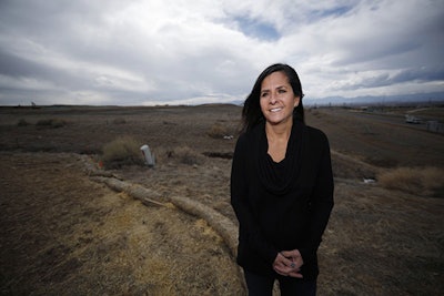 In this Feb. 28, 2019, photograph, Lizzie Lario, a member of the Wildgrass Oil and Gas Committee, poses for a picture near the construction site of a well pad near her family home in Broomfield, Colo. Frustrated Colorado residents say state law is forcing them to participate in an oil and gas drilling project against their wishes, so they launched legal challenges with potentially significant consequences for the industry. Lario said she did not want to participate in something that could result in spills, fires and explosions so close to homes. (AP Photo/David Zalubowski)
