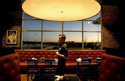 In this Jan. 9, 2019, file photo tables sit empty during dinnertime at Rocket City Tavern near numerous federal agencies in Huntsville, Ala. Image credit: AP Photo/David Goldman, File