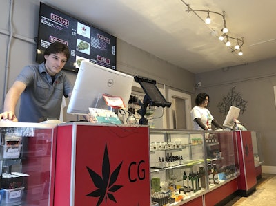 In this Wednesday, March 6, 2019 photo, Korbin Osborn, left, works as a cannabis adviser at a medical marijuana dispensary in Santa Fe, N.M. Image credit: AP Photo/Morgan Lee