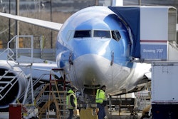 Workers walk past a Boeing 737 MAX 8 airplane being built for TUI Group at Boeing Co.'s Renton Assembly Plant Wednesday, March 13, 2019, in Renton, Wash. Image credit: AP Photo/Ted S. Warren