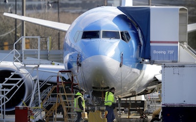 Workers walk past a Boeing 737 MAX 8 airplane being built for TUI Group at Boeing Co.'s Renton Assembly Plant Wednesday, March 13, 2019, in Renton, Wash. Image credit: AP Photo/Ted S. Warren