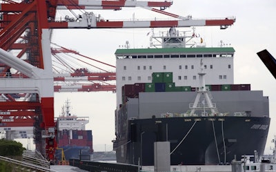 In this June 18, 2018, file photo, a container ship, right, arrives at a container terminal in Tokyo. Image credit: AP Photo/Koji Sasahara, File