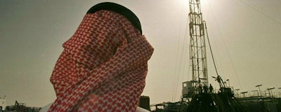 In this Feb. 26, 1997 file photo, Khaled al-Otaiby, an official of the Saudi oil company Aramco, watches progress at a rig at the al-Howta oil field near Howta, Saudi Arabia. According to an assessment published Monday, April 1, 2019, by Moody’s Investors Services, the net profits of Saudi Aramco reached $111 billion last year. That places Aramco ahead of some of the world’s most profitable firms. In their first-ever grade assessment for Aramco, Fitch Ratings issued the firm an A+ rating, while Moody’s gave it it’s A1 rating ahead of its upcoming bonds sale. (AP Photo/John Moore)