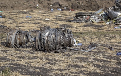 In this March 11, 2019, file photo airplane parts lie on the ground at the scene of an Ethiopian Airlines flight crash near Bishoftu, or Debre Zeit, south of Addis Ababa, Ethiopia. Image credit: AP Photo/Mulugeta Ayene, File