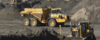 In this Nov. 14, 2017 file photo, crews with Duke Energy continue to remove coal ash from the old coal ponds at the Sutton Plant, in Wilmington, N.C. Duke Energy Corp., the country’s largest electric company, was ordered Monday, April 1, 2019 to excavate coal ash from all of its North Carolina power plant sites, slashing the risk of toxic chemicals leaking into water supplies but potentially adding billions of dollars to the costs consumers pay. (Ken Blevins /The Star-News via AP)