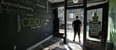 In this photo taken Thursday, March 21, 2019, Gus Dabais stands in the entry to his Sidewalk Wellness store in San Francisco. Image credit: AP Photo/Eric Risberg