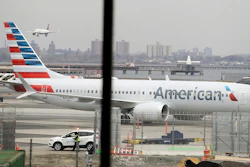 In a March 13, 2019 file photo, an American Airlines Boeing 737 MAX 8 sits at a boarding gate at LaGuardia Airport in New York. Image credit: AP Photo/Frank Franklin II, File