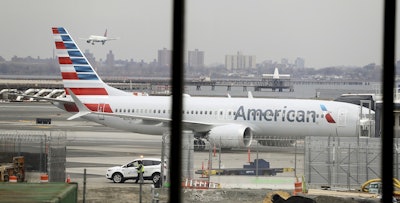 In a March 13, 2019 file photo, an American Airlines Boeing 737 MAX 8 sits at a boarding gate at LaGuardia Airport in New York. Image credit: AP Photo/Frank Franklin II, File