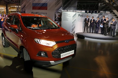 In this photo taken on Tuesday, Dec. 2, 2014, Russian Prime Minister Dmitry Medvedev, second right, attends the launch of Ford EcoSport production during a visit to Ford Sollers at a plant in Naberezhnye Chelny, in the Russia's region of Tatarstan, about 700 kilometers (450 miles) east of Moscow, Russia. Image credit: Dmitry Astakhov, Sputnik, Government Pool Photo via AP