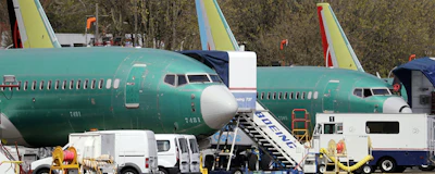 In this Monday, April 8, 2019, file photo, Boeing 737 Max 8 jets, built for American Airlines, left, and Air Canada are parked at the airport adjacent to a Boeing Co. production facility in Renton, Wash. Orders and deliveries of Boeing's 737 Max plunged in the first quarter as the plane was grounded around the world following a second deadly crash. Boeing disclosed Tuesday, April 9, that it received no new orders for the Max in March. (AP Photo/Elaine Thompson)