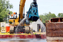 In this June 10, 2011 file photo, crews dredge the Hudson River in Fort Edward, N.Y. Image credit: AP Photo/Mike Groll, File