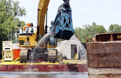 In this June 10, 2011 file photo, crews dredge the Hudson River in Fort Edward, N.Y. Image credit: AP Photo/Mike Groll, File