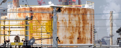 In this Sept. 18, 2009, file photo, a man works at the Exxon Mobil refinery in Baytown, Texas. Exxon Mobil says it plans to spend $2 billion to expand a chemicals plant next to the Houston Ship Channel and that the project will create 2,000 temporary construction jobs. The company said Thursday, May 2, 2019, it will build a new unit at the Baytown plant to make chemical compounds that give plastics more elasticity and flexibility, and produce ingredients used in engine and industrial oils. Exxon says the facility should begin operating in 2022. (AP Photo/Pat Sullivan)