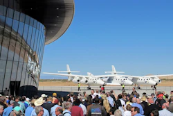 In this Oct. 17, 2011, file photo a crowd gathers outside Spaceport America for a dedication ceremony as Virgin Galactic's mothership WhiteKnightTwo sits on the tarmac near Upham, N.M. Image credit: AP Photo/Susan Montoya Bryan, File