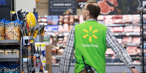 FILE - In this April 24, 2019, file photo a Walmart associate works at a Walmart Neighborhood Market in Levittown, N.Y. Walmart Inc. reports earnings on Thursday, May 16. (AP Photo/Mark Lennihan, File)