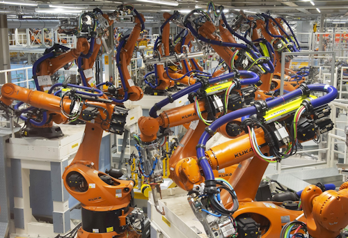 In this Tuesday, May 14, 2019 photo, robot arms stand at the assembly line during the reconstruction for the electrical car body construction at a press tour at the plant of the German manufacturer Volkswagen AG (VW) in Zwickau, Germany. Image credit: AP Photo/Jens Meyer