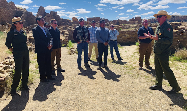 In this photo provided by the Navajo Nation, Nathan Hatfield, chief of interpretation at Chaco Culture National Historical Park, speaks to Interior Secretary David Bernhardt, tribal leaders and others during a tour Tuesday, May 28, 2019 at the site about 95 miles northeast of Gallup, New Mexico. Image credit: Jared Touchin/Navajo Nation via AP