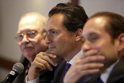 In this Aug. 17, 2017 file photo, flanked by lawyer Javier Coello Trejo, left, Emilio Lozoya, former head of Mexico's state-owned oil company Pemex, attends a press conference, in Mexico City. Image credit: AP Photo/Gustavo Martinez Contreras, File