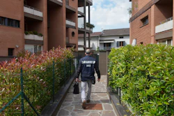 A police officer arrives to search Dr. Guido Fanelli's house in Parma, Italy, on Monday, May 8, 2017. Image credit: AP Photo/Marco Vasini