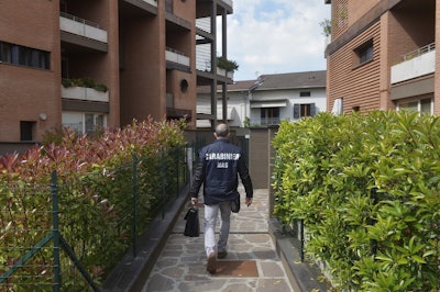 A police officer arrives to search Dr. Guido Fanelli's house in Parma, Italy, on Monday, May 8, 2017. Image credit: AP Photo/Marco Vasini