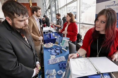 In this March 7, 2019, file photo visitors to the Pittsburgh veterans job fair meet with recruiters at Heinz Field in Pittsburgh. Image credit: