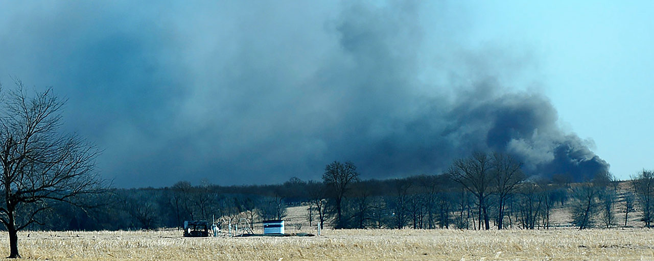 In this Monday, Jan. 22, 2018, file photo, smoke billows from the site of a gas well fire near Quinton, Okla. A federal report says the explosion and fire that killed five workers at the southeastern Oklahoma natural gas well in 2018 was caused by the failure of blowout prevention devices and other factors. (Kevin Harvison/The McAlester News-Capital via AP)