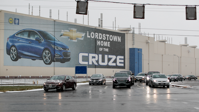 In this Nov. 27, 2018 file photo, a banner depicting the Chevrolet Cruze model vehicle is displayed at the General Motors' Lordstown plant in Lordstown, OH.