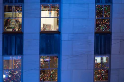 In this Nov. 28, 2018 file photo, people work in their office after the Rockefeller Center Christmas tree is lit during the 86th annual Rockefeller Center Christmas tree lighting ceremony in New York.
