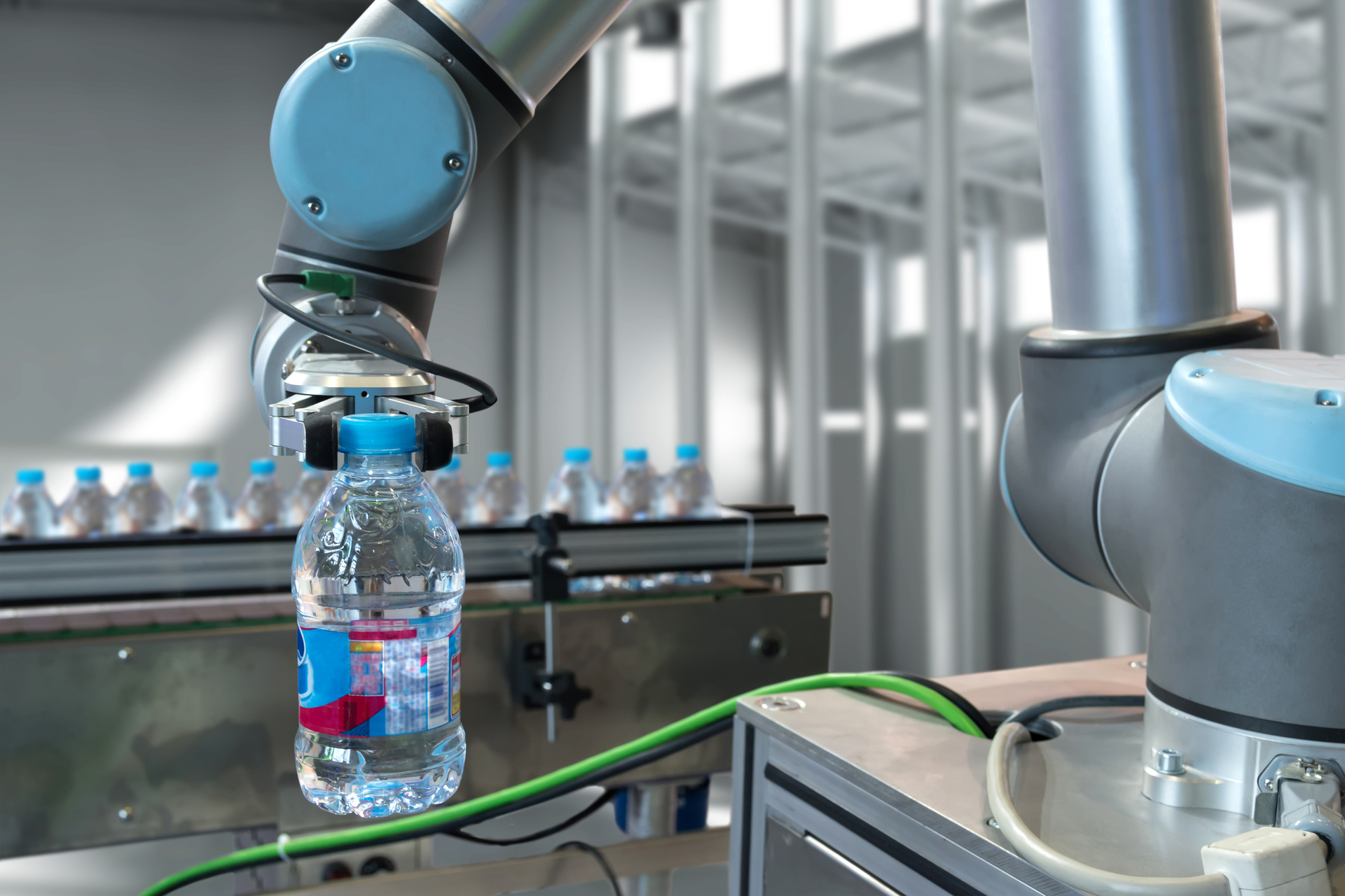 Automatic Manufacturing Production Machine , Robot Gripper Warehouse Picking Holding Water Bottle In Smart Factory 838450804 2125x1416 (1)