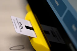 In this Nov. 5, 2019 file photo, an electronic card with ballot information is seen inserted in a voting machine in Dallas, GA.