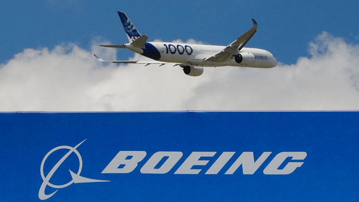 In this June 17, 2019, file photo, an Airbus A 350 - 1000 performs his demonstration flight at Paris Air Show in Le Bourget, east of Paris, France. Boeing's grounded 737 Max got a boost from two orders in November, but the American aircraft company continues to trail Europe's Airbus in both orders and deliveries of airline planes. Boeing disclosed Tuesday, Dec. 10, that it received 11 net orders in November, 63 new orders but 52 cancellations.