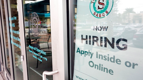 In this Nov. 4, 2019, file photo a job posting is displayed near the entrance outside a restaurant in Orlando, Fla. Two reports last week show that small business hiring still lags behind the strong job growth reported at larger companies, and that owners are unlikely to increase their staffs significantly in 2020.
