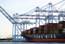 In this Nov. 4, 2019 file photo, cargo cranes are used to take containers off of a Yang Ming Marine Transport Corporation boat at the Port of Tacoma in Tacoma, WA.
