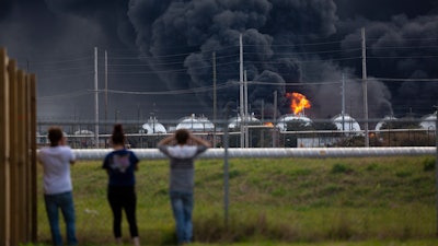 Residents observe the fire consuming the TPC Group plant on Wednesday, Nov. 27, in Port Neches, TX.