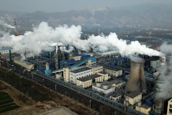 In this Nov. 28, 2019 photo, smoke and steam rise from a coal processing plant that produces carbon black, an ingredient in steel manufacturing, in Hejin in central China's Shanxi Province.