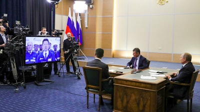 Russian President Vladimir Putin, right, Deputy Prime Minister of Russia Dmitry Kozak, second right, and Russian Minister of Energy Alexander Novak, back to a camera attend a joint video conference with Chinese President Xi Jinping during inaugurating the Power of Siberia pipeline in the Bocharov Ruchei residence in the Black Sea resort of Sochi, Russia on Monday, Dec. 2.