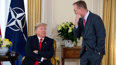 White House chief of staff Mick Mulvaney talks with US President Donald after his meeting with NATO Secretary General Jens Stoltenberg at Winfield House on Tuesday, Dec. 3, in London.
