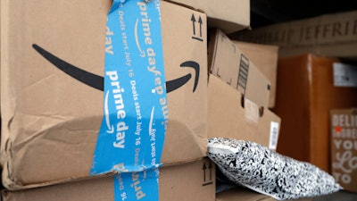 In this July 17, 2018 file photo, Amazon Prime packages sit in a delivery truck before being unloaded in Miami.