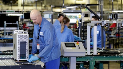 In this Nov. 20, 2019 file photo, workers assemble Apple products at an Apple manufacturing plant in Austin, TX.