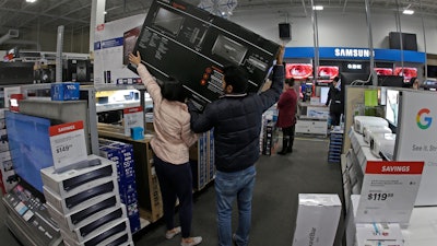In this Nov. 28, file photo, people shop at a Best Buy store during a Black Friday sale in Overland Park, KS.