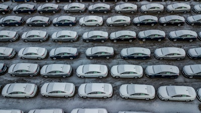 In this Dec. 5, 2018 file photo, hundreds of Chevrolet Cruze cars sit in a parking lot at General Motors' assembly plant in Lordstown, OH. The long-struggling Rust Belt community of Youngstown, Ohio, which was stung by the loss of the massive General Motors Lordstown plant this year, wants to become a research and production hub for electric vehicles.. But Youngstown faces competition from places like Detroit and China that are taking big roles in developing electric vehicles.
