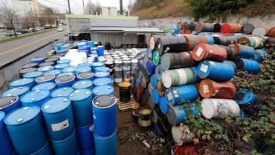 Dozens of barrels fill an outside storage area at Seattle Barrel and Cooperage Wednesday, Dec. 18, 2019, in Seattle. The century-old Seattle barrel company has been indicted along with its third-generation owner in what prosecutors describe as a long-running pollution conspiracy. The 36-count indictment, made public in U.S. District Court in Seattle on Wednesday, says the company used a hidden drain to pump caustic wastewater directly into the King County sewer system. That's despite telling officials that the company reused all its wastewater and didn't discharge any.