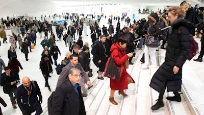 In this Dec. 4, 2019, file photo commuters pass through the World Trade Center in New York. A study by a U.S. agency has found that facial recognition technology often performs unevenly based on a person's race, gender or age. This is the first time the National Institute of Standards and Technology has investigated demographic differences in how face-scanning algorithms are able to identify people.