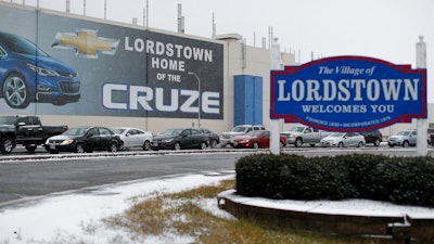 In this Nov. 27, 2018, file photo a banner depicting the Chevrolet Cruze model vehicle is displayed at the General Motors' Lordstown plant in Lordstown, Ohio. General Motors is selling the Ohio assembly plant it closed in March to a new company that plans to begin making electric trucks in late 2020. The company called Lordstown Motors Corp. said Thursday, Nov. 7, 2019, that it initially intends to hire 400 production workers but still needs more money from investors.
